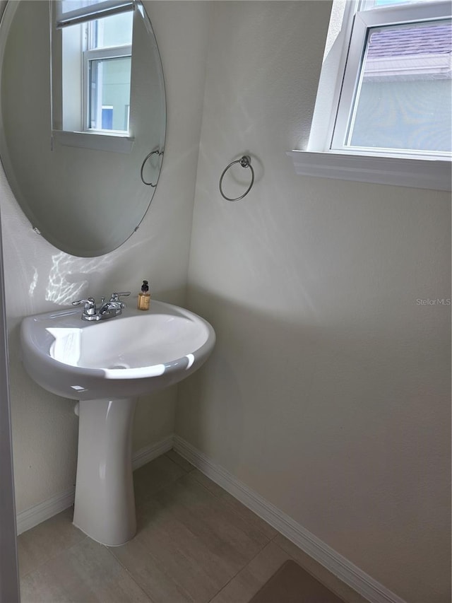 1764 Stamen Dr, Kissimmee, FL 34744 - bathroom with baseboards and tile patterned flooring