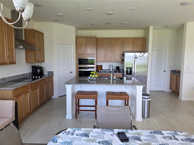 1764 Stamen Dr, Kissimmee, FL 34744 - kitchen featuring a kitchen island with sink, appliances with stainless steel finishes, light tile patterned flooring, and wall chimney range hood