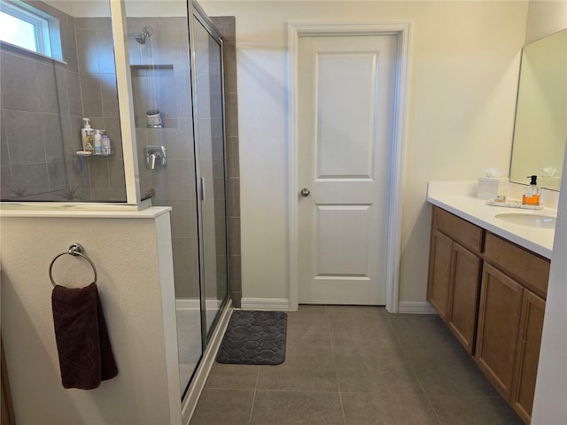1764 Stamen Dr, Kissimmee, FL 34744 - bathroom with a stall shower, vanity, baseboards, and tile patterned floors