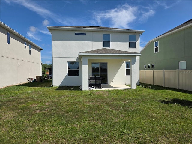 1764 Stamen Dr, Kissimmee, FL 34744 - rear view of house with a yard, a patio, stucco siding, and fence