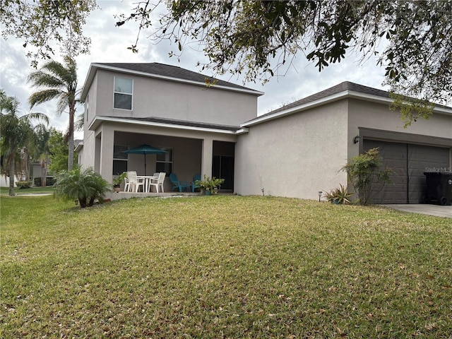 987 Alston Bay Blvd, Apopka, FL 32703 - back of house with stucco siding, a lawn, concrete driveway, and a garage