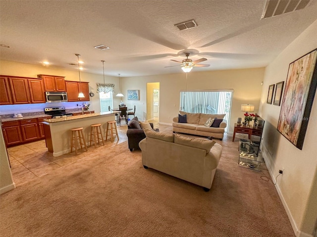 987 Alston Bay Blvd, Apopka, FL 32703 - living room with a wealth of natural light, visible vents, a ceiling fan, and light colored carpet
