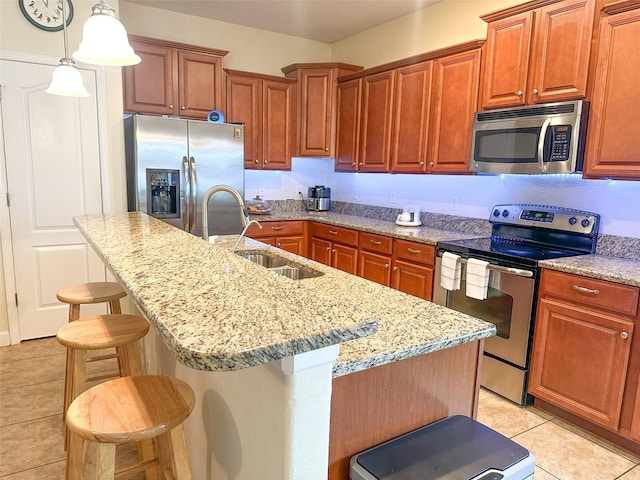 987 Alston Bay Blvd, Apopka, FL 32703 - kitchen with a kitchen breakfast bar, light tile patterned floors, light stone counters, a sink, and stainless steel appliances