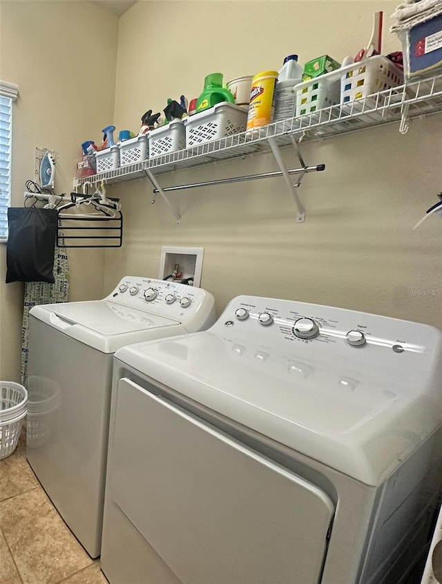 987 Alston Bay Blvd, Apopka, FL 32703 - laundry area with light tile patterned flooring, laundry area, and washer and clothes dryer