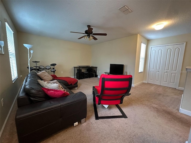 987 Alston Bay Blvd, Apopka, FL 32703 - carpeted living room featuring a textured ceiling, ceiling fan, visible vents, and a healthy amount of sunlight