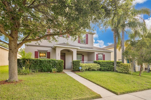 987 Alston Bay Blvd, Apopka, FL 32703 - traditional-style home featuring stucco siding, a front lawn, covered porch, and roof with shingles