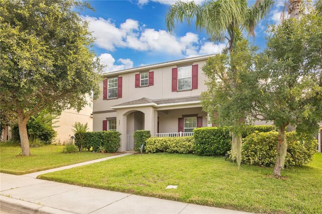 987 Alston Bay Blvd, Apopka, FL 32703 - traditional-style home with stucco siding, a front yard, and covered porch