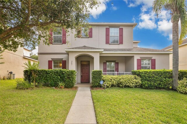 987 Alston Bay Blvd, Apopka, FL 32703 - traditional-style house featuring stucco siding, a front yard, a porch, and roof with shingles