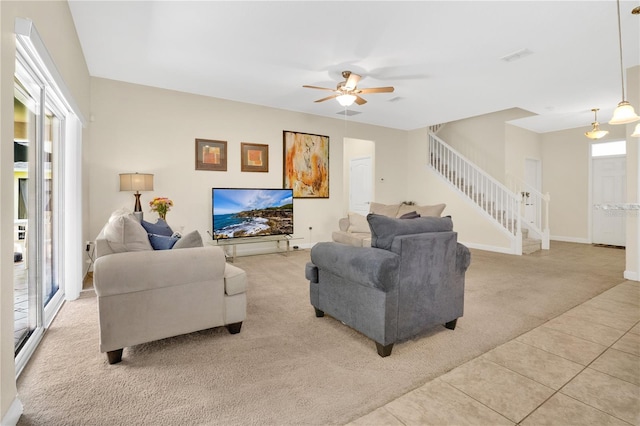 987 Alston Bay Blvd, Apopka, FL 32703 - living area featuring light colored carpet, stairway, a ceiling fan, and light tile patterned floors