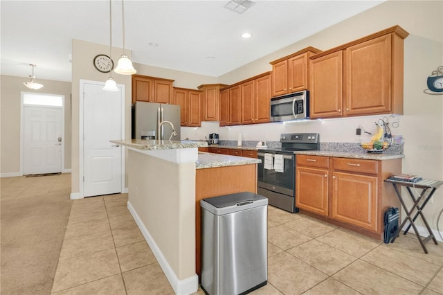 987 Alston Bay Blvd, Apopka, FL 32703 - kitchen with stainless steel appliances, light tile patterned floors, a kitchen island with sink, light stone counters, and recessed lighting