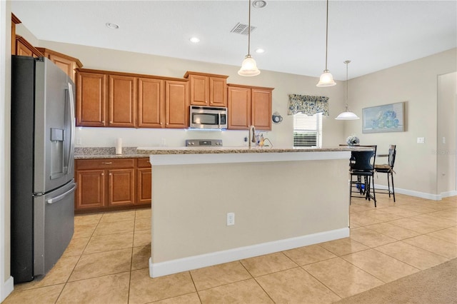 987 Alston Bay Blvd, Apopka, FL 32703 - kitchen featuring stainless steel appliances, brown cabinets, light tile patterned floors, hanging light fixtures, and recessed lighting