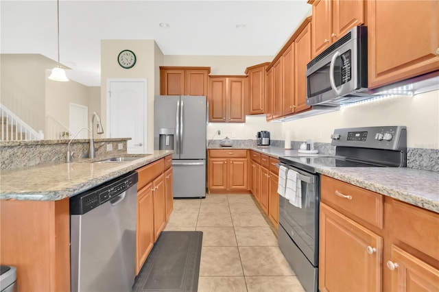 987 Alston Bay Blvd, Apopka, FL 32703 - kitchen with stainless steel appliances, light tile patterned floors, decorative light fixtures, and light stone countertops