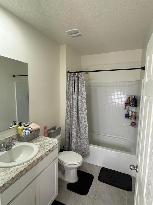 7162 Tigereye Way, Grant, FL 32949 - bathroom featuring vanity, shower / tub combo, tile patterned floors, and a textured ceiling