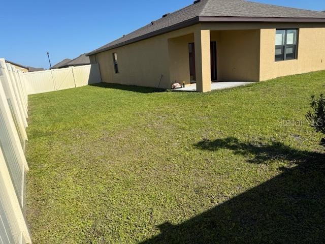 7162 Tigereye Way, Grant, FL 32949 - fenced backyard featuring a patio