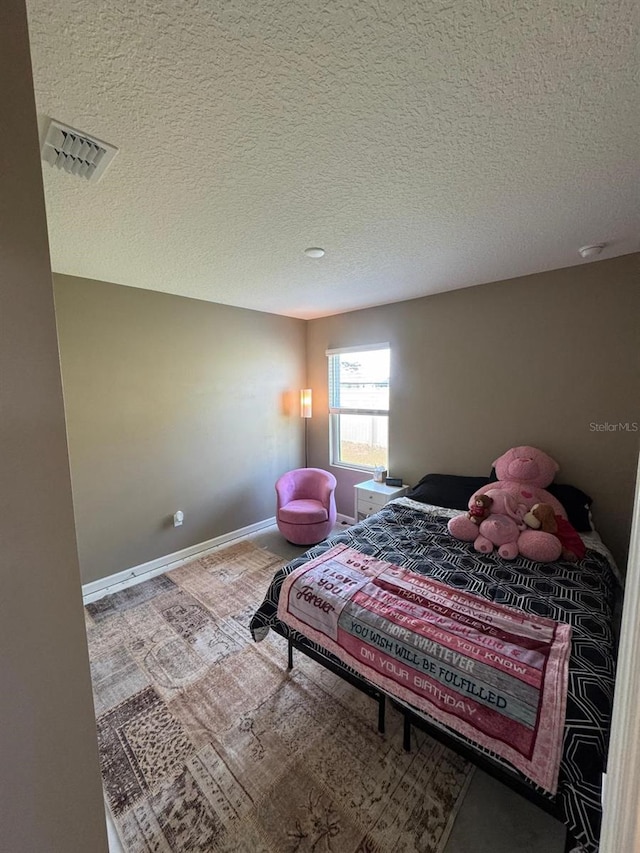 7162 Tigereye Way, Grant, FL 32949 - carpeted bedroom featuring a textured ceiling and baseboards