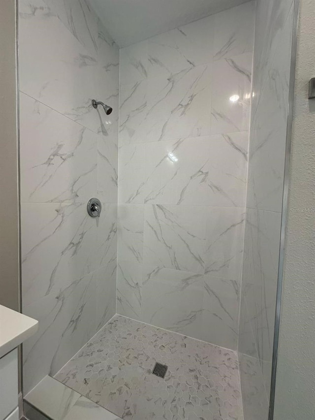 full bath with a stall shower and vanity