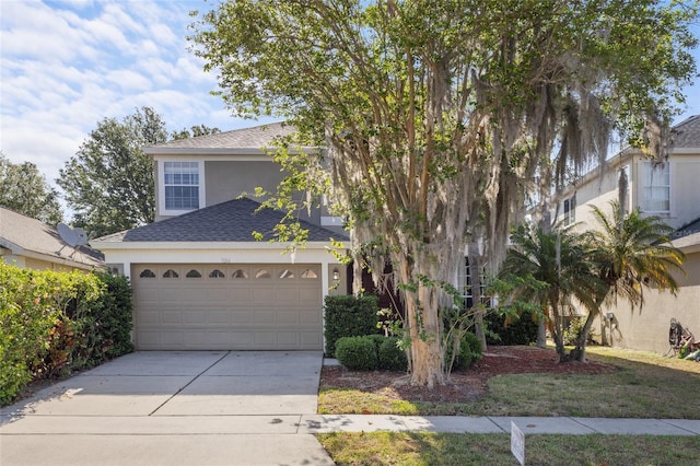 9244 Pecky Cypress Way, Orlando, FL 32836 - view of front of property featuring an attached garage, a shingled roof, stucco siding, and driveway