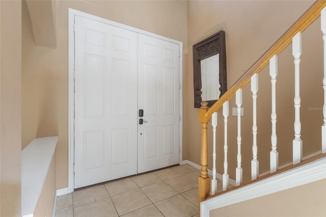 9244 Pecky Cypress Way, Orlando, FL 32836 - entrance foyer with stairs, tile patterned floors, and baseboards