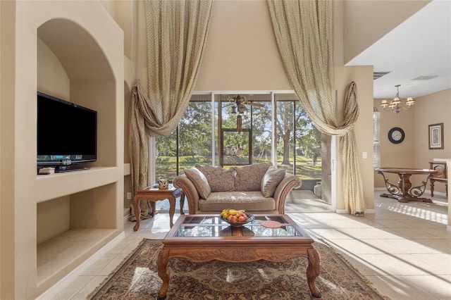 9244 Pecky Cypress Way, Orlando, FL 32836 - living room featuring a high ceiling, a notable chandelier, a healthy amount of sunlight, and light tile patterned floors