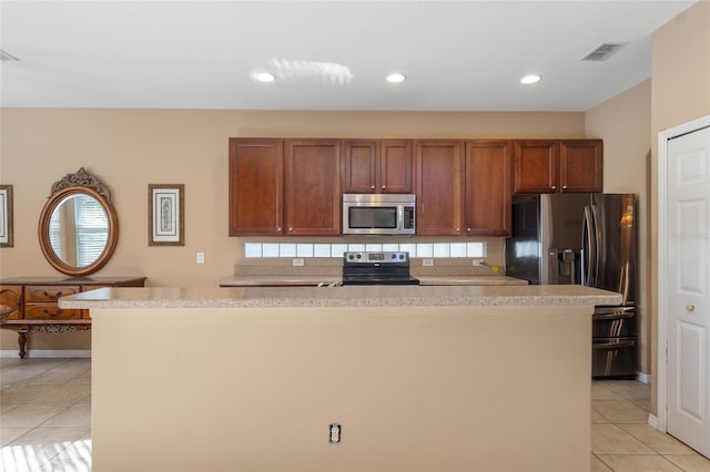 9244 Pecky Cypress Way, Orlando, FL 32836 - kitchen with light countertops, stainless steel appliances, light tile patterned flooring, and visible vents