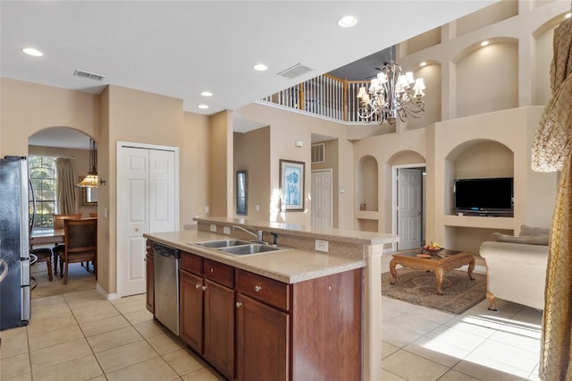 9244 Pecky Cypress Way, Orlando, FL 32836 - kitchen with light countertops, stainless steel appliances, open floor plan, light tile patterned floors, and visible vents