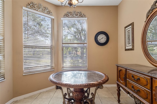 9244 Pecky Cypress Way, Orlando, FL 32836 - dining room featuring baseboards, a chandelier, and light tile patterned flooring