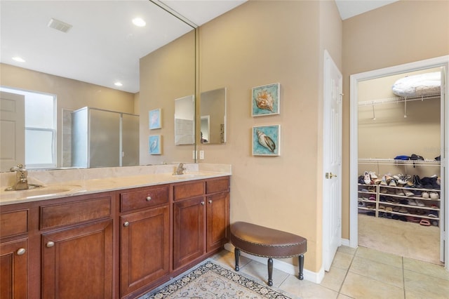 9244 Pecky Cypress Way, Orlando, FL 32836 - full bath featuring double vanity, tile patterned floors, a sink, and a stall shower