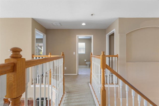 9244 Pecky Cypress Way, Orlando, FL 32836 - hall with plenty of natural light, baseboards, visible vents, and an upstairs landing