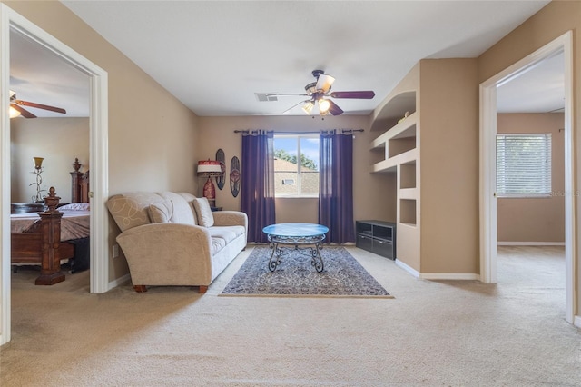 9244 Pecky Cypress Way, Orlando, FL 32836 - living area featuring visible vents, carpet flooring, baseboards, and ceiling fan
