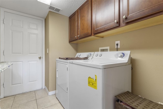 9244 Pecky Cypress Way, Orlando, FL 32836 - washroom with visible vents, baseboards, separate washer and dryer, cabinet space, and light tile patterned floors