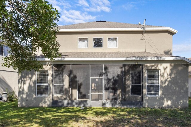 9244 Pecky Cypress Way, Orlando, FL 32836 - back of house with a lawn, a sunroom, and stucco siding