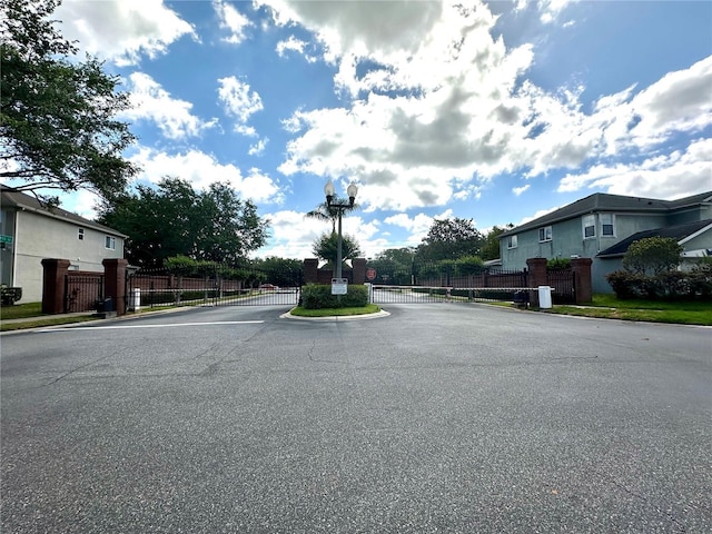 9244 Pecky Cypress Way, Orlando, FL 32836 - view of road with a gate, a gated entry, curbs, and street lights