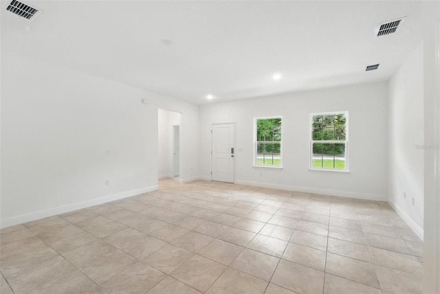 spare room with light tile patterned flooring, recessed lighting, and baseboards