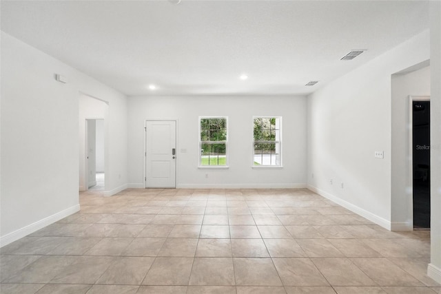 spare room with light tile patterned flooring, recessed lighting, and baseboards