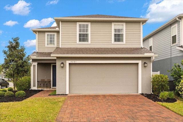 4301 Creek Bank Dr, Kissimmee, FL 34744 - traditional home with an attached garage, stucco siding, decorative driveway, and roof with shingles