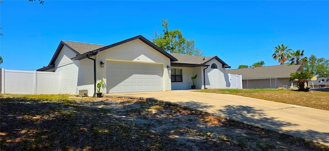 view of front facade with brick siding, fence, driveway, and a garage