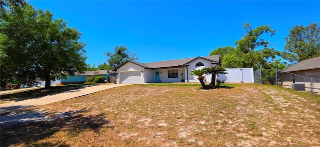 single story home with fence, an attached garage, and concrete driveway