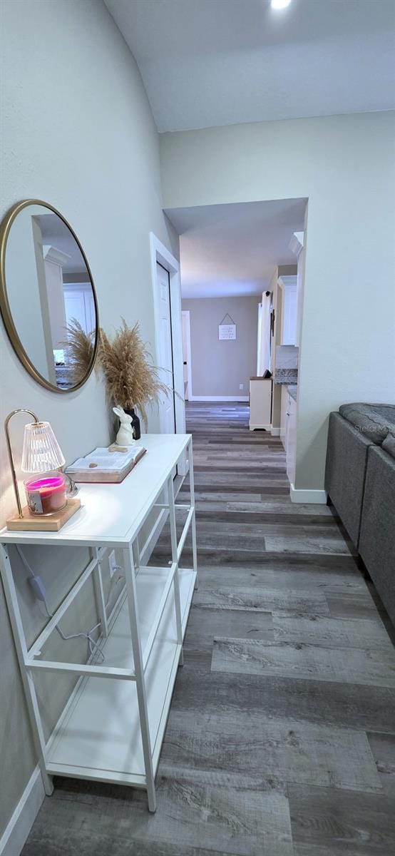 hall with wood finished floors and baseboards
