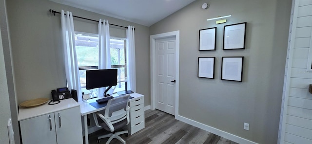 office featuring lofted ceiling, wood finished floors, and baseboards