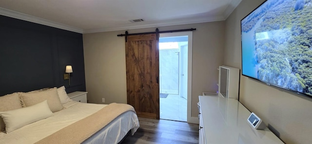 bedroom featuring multiple windows, crown molding, wood finished floors, and visible vents