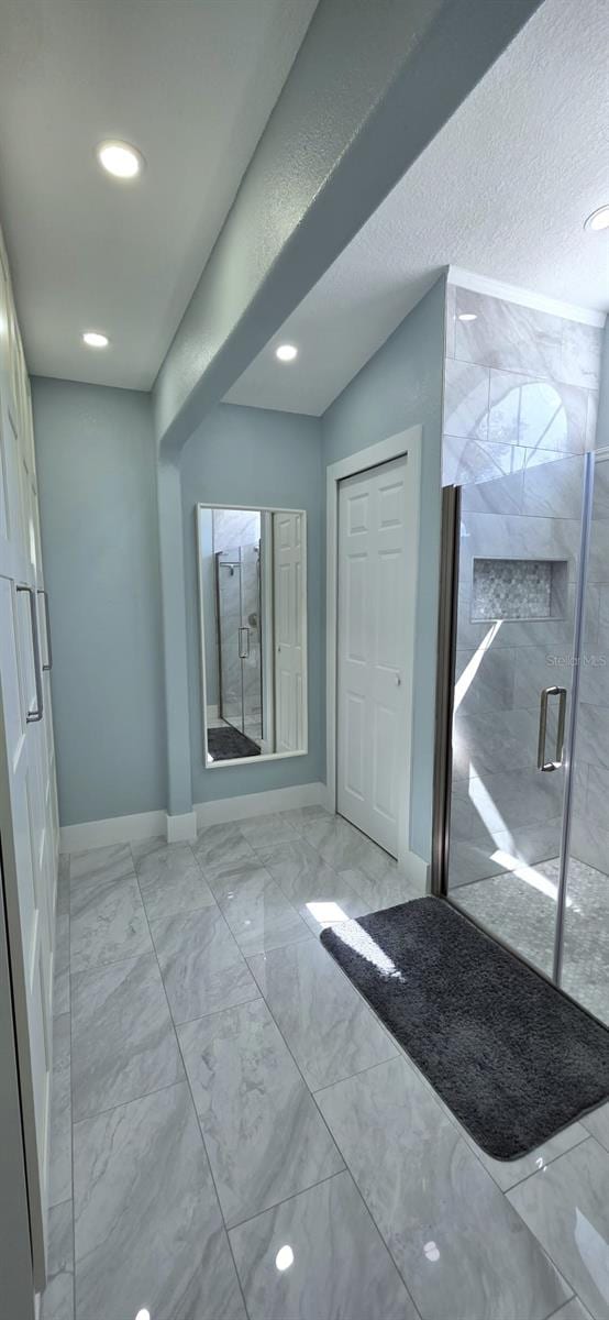 interior space featuring recessed lighting, marble finish floor, and baseboards