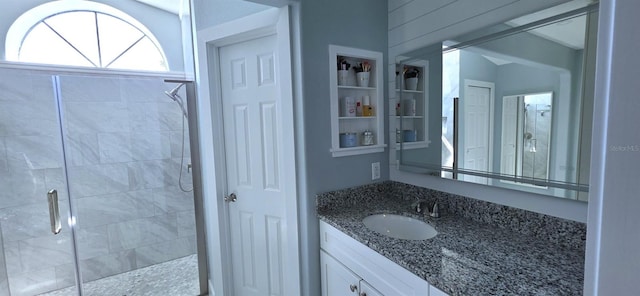 full bathroom featuring a shower stall and vanity