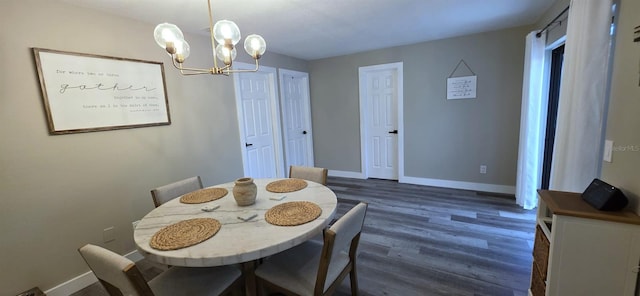 dining room with dark wood-style floors, baseboards, and a chandelier