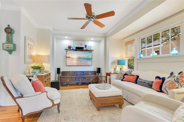 living room with crown molding, ceiling fan, and wood finished floors