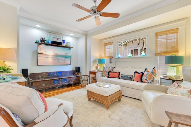 living area featuring wood finished floors, a ceiling fan, ornamental molding, and recessed lighting