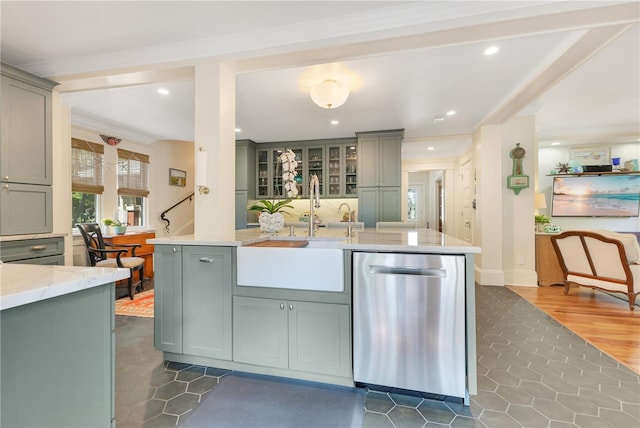 kitchen featuring stainless steel dishwasher, a sink, light stone countertops, recessed lighting, and gray cabinets