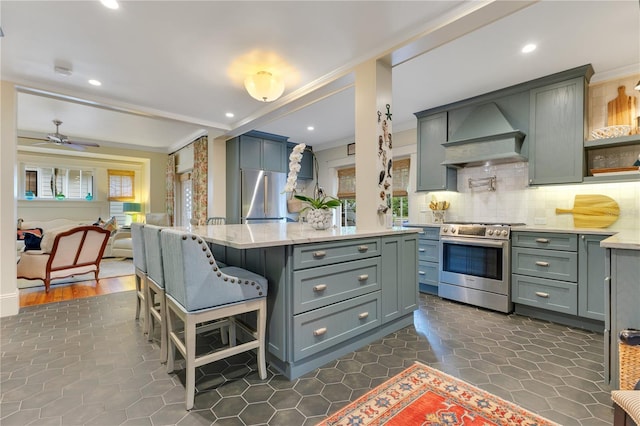 kitchen with decorative backsplash, crown molding, stainless steel appliances, a center island, and custom exhaust hood