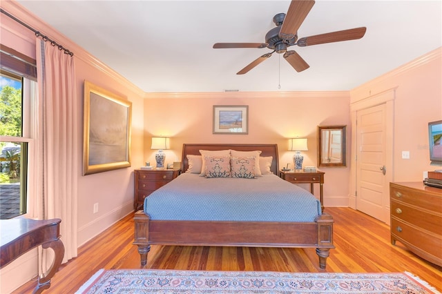 bedroom featuring light wood-style floors, ceiling fan, baseboards, visible vents, and crown molding