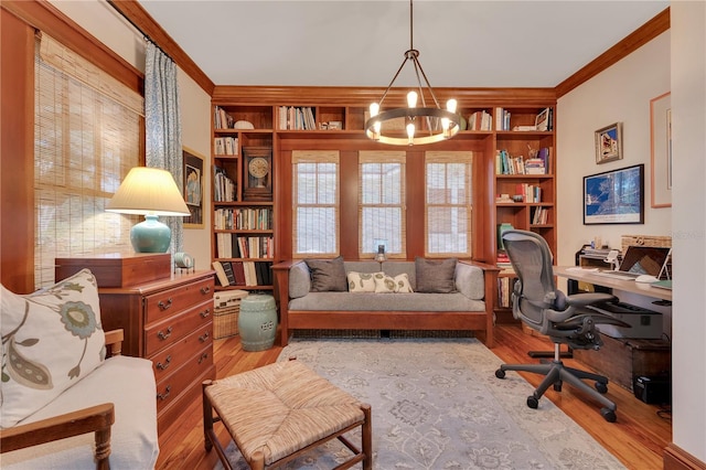 office area featuring built in shelves, a notable chandelier, wood finished floors, and ornamental molding