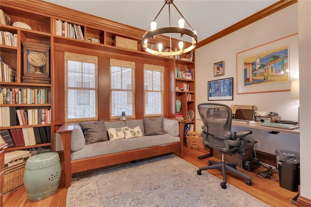 office featuring a wealth of natural light, wood finished floors, an inviting chandelier, and ornamental molding